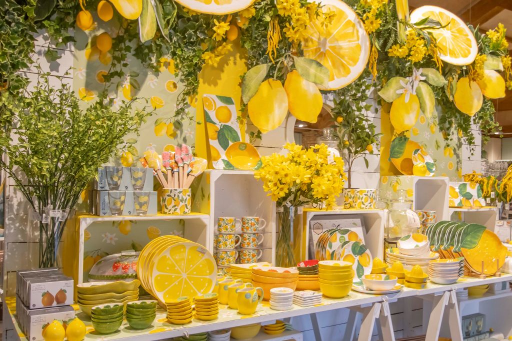 Image of a table in Cook Shop displaying a range of lemon indoor and outdoor tableware.