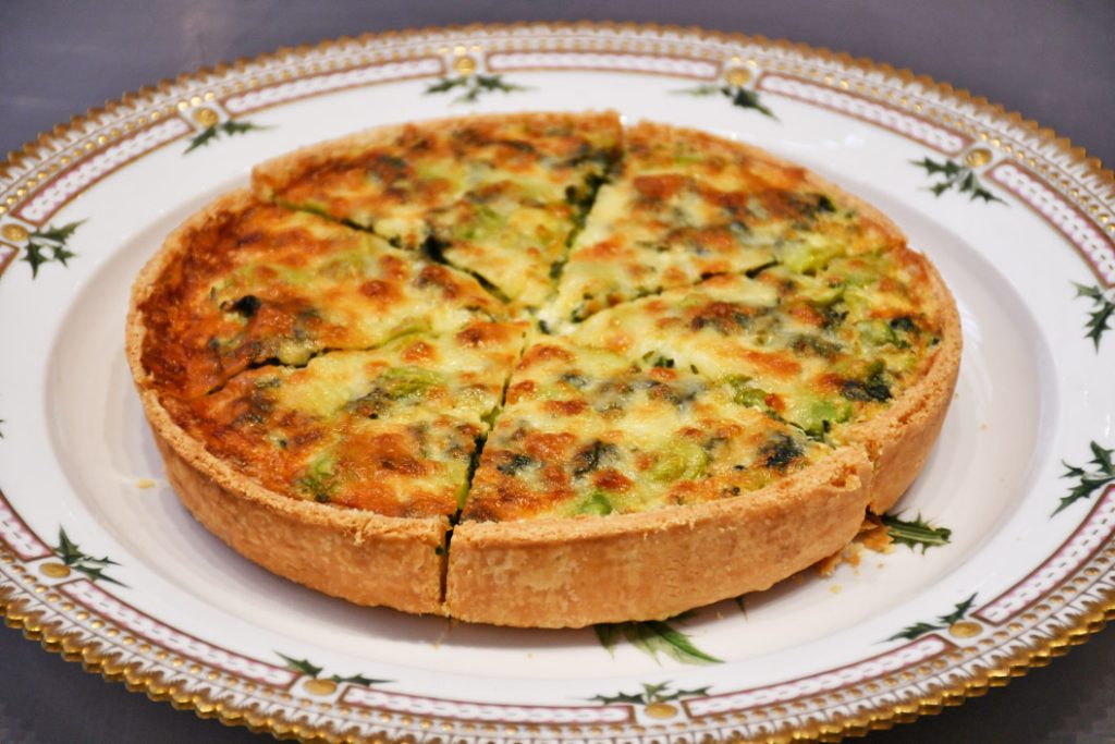Image of The Coronation Quiche on gold and white floral plate.
