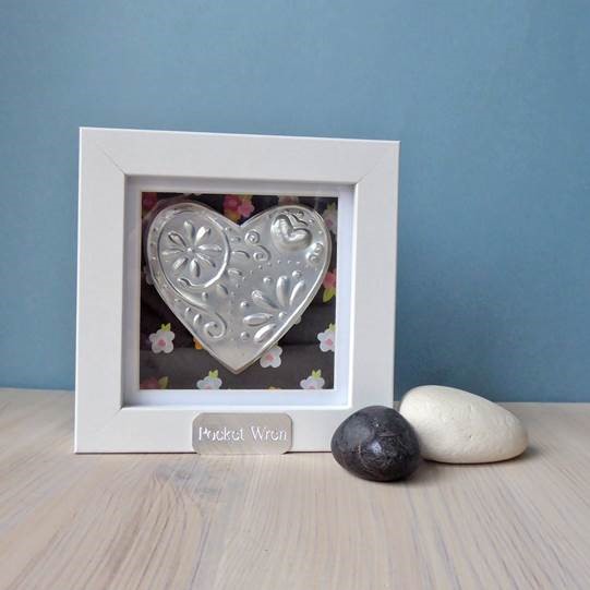 Embossed metal heart in a white frame